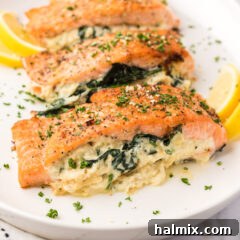 Close up photo of Stuffed Salmon on a platter, highlighting the golden sear and delicious filling.