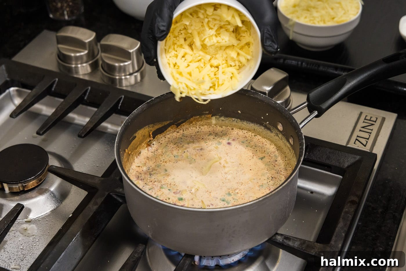 adding cheese to saucepan with evaporated milk mixture