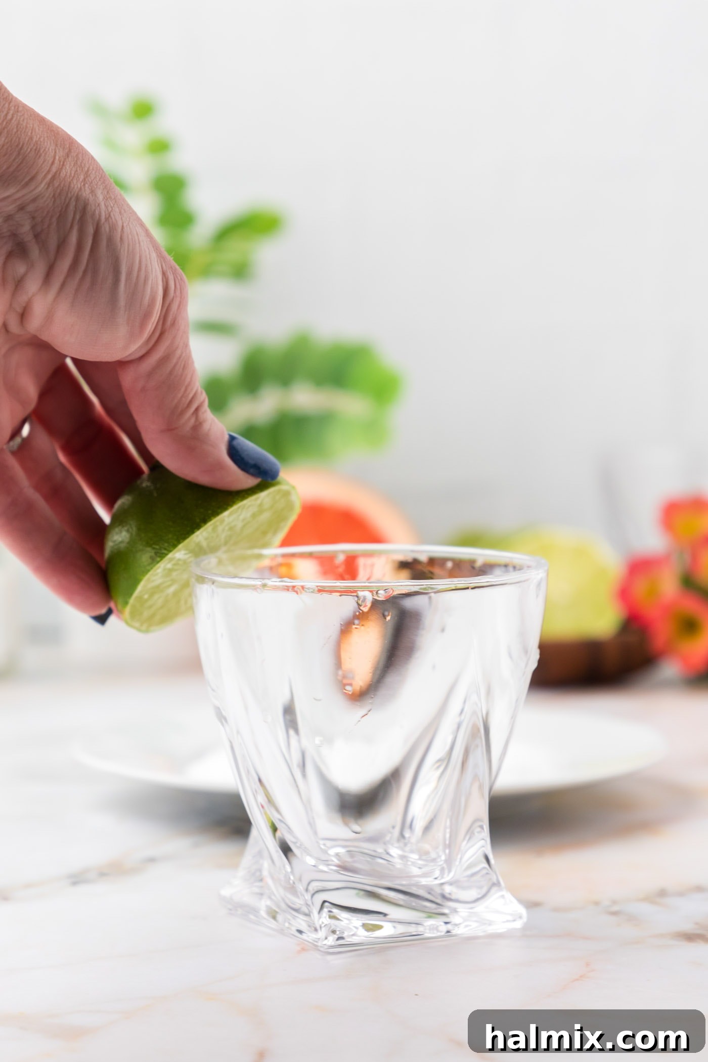 rubbing the rim of cocktail glass with lime