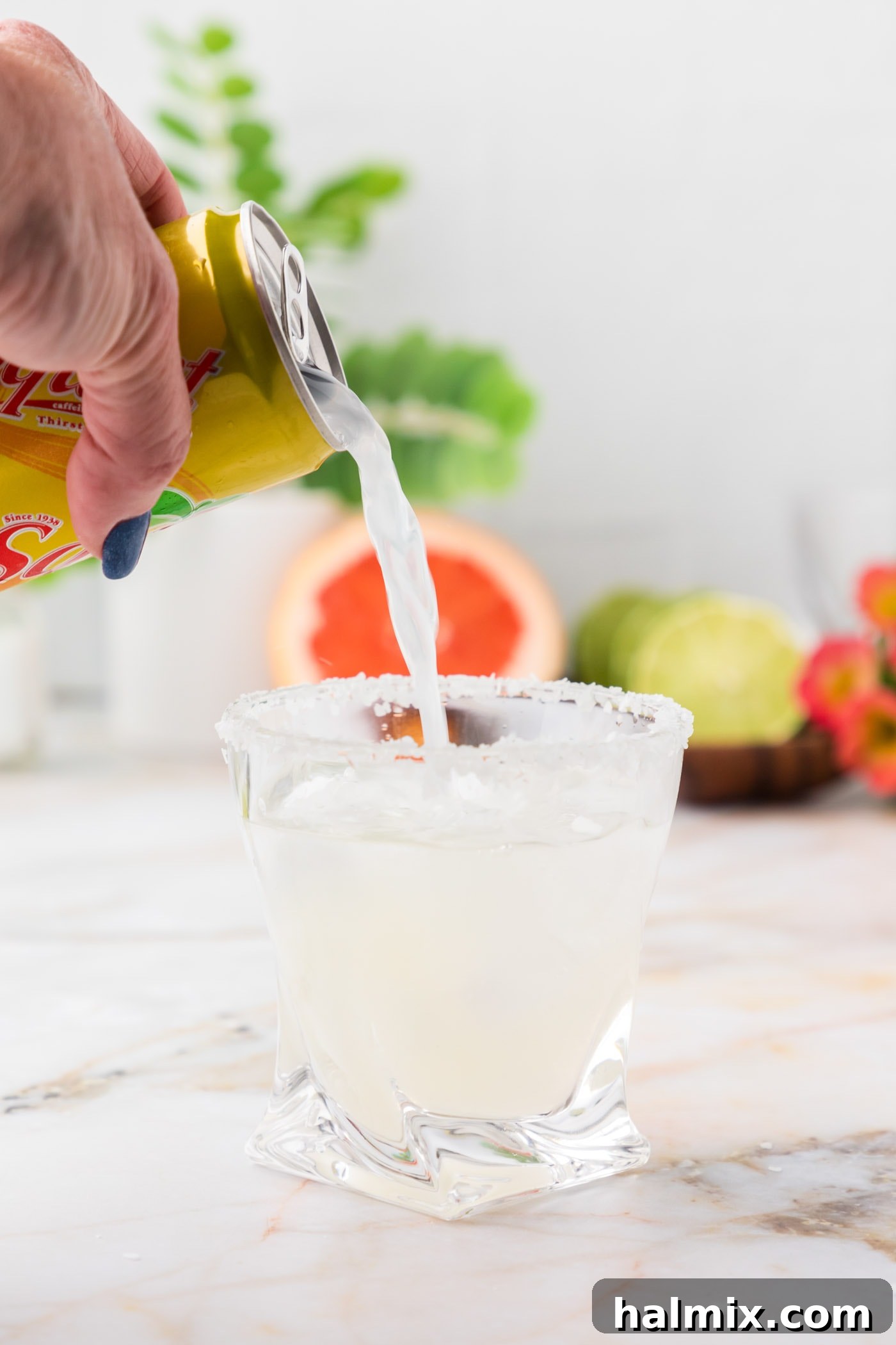 adding grapefruit soda to lime juice and tequila