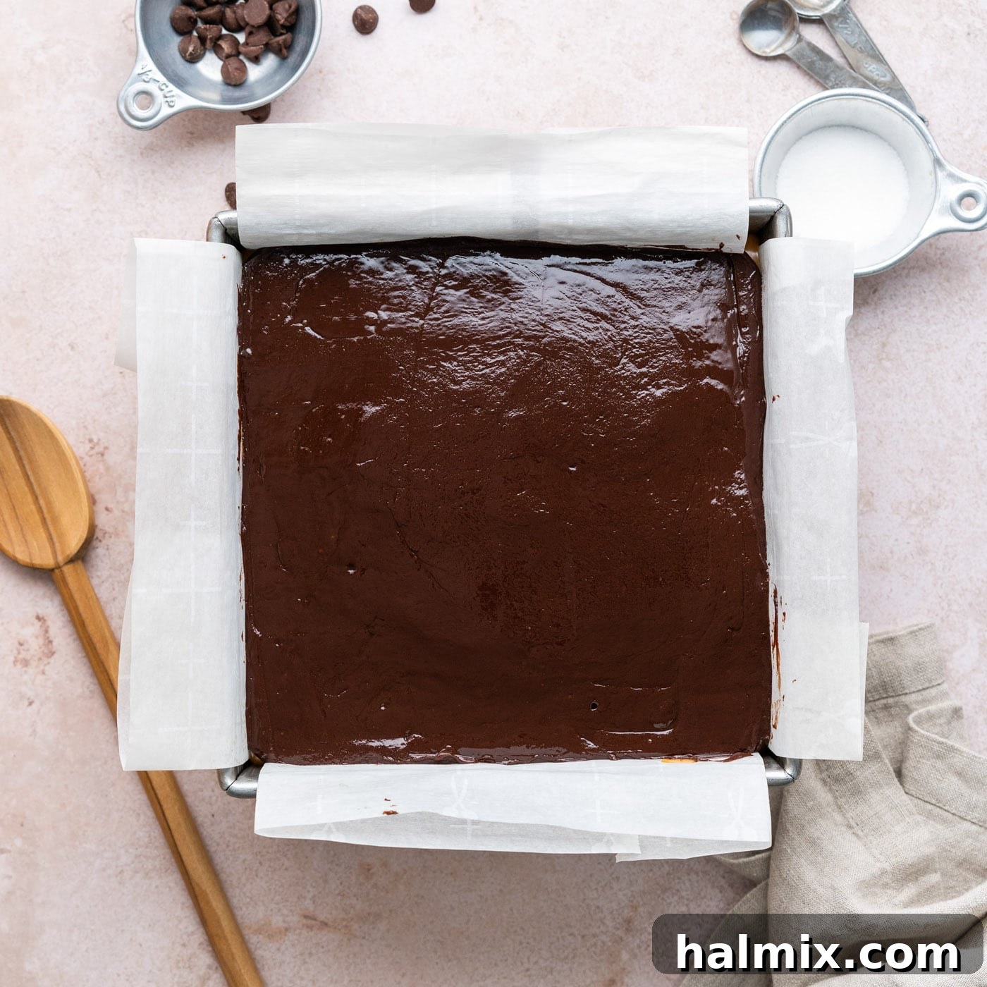 overhead of chocolate ganache on top of caramel and brownies