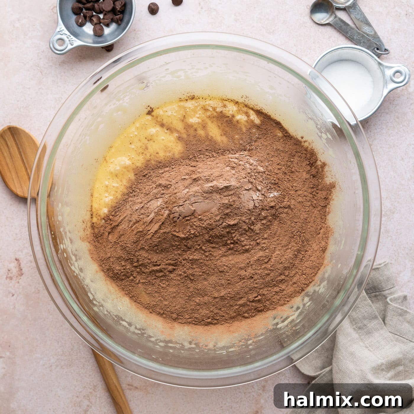 adding dry ingredients to wet ingredients for brownies