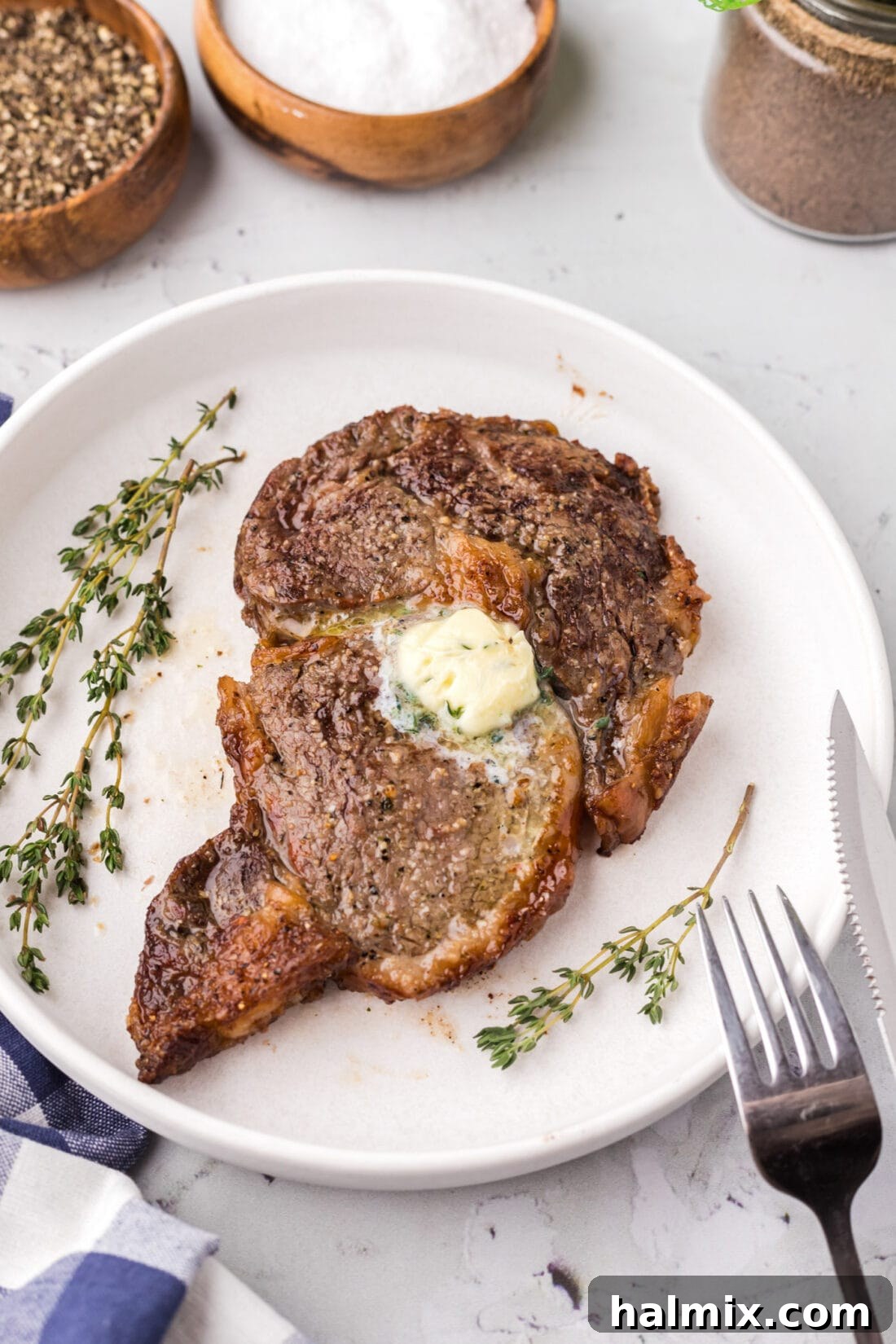 A perfectly cooked Air Fryer Steak resting on a plate, garnished and ready for serving.