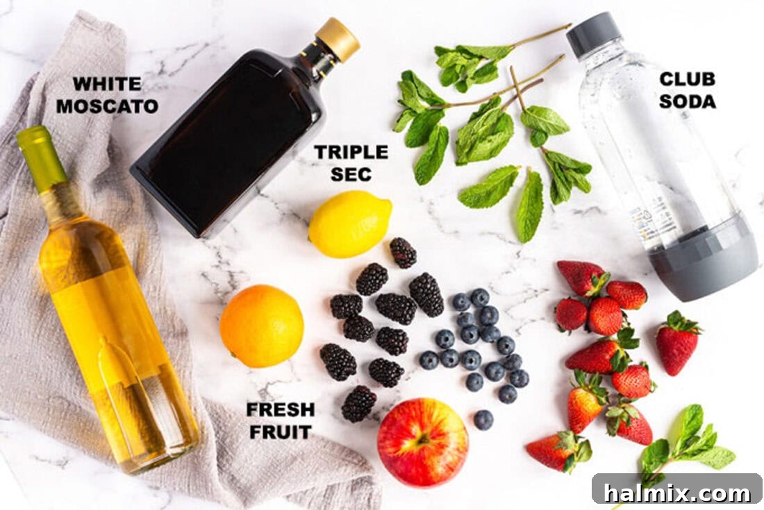 Sun-Kissed Sangria 4 A flat lay of ingredients for white sangria, including a bottle of Moscato, an orange, a lemon, strawberries, and blueberries.