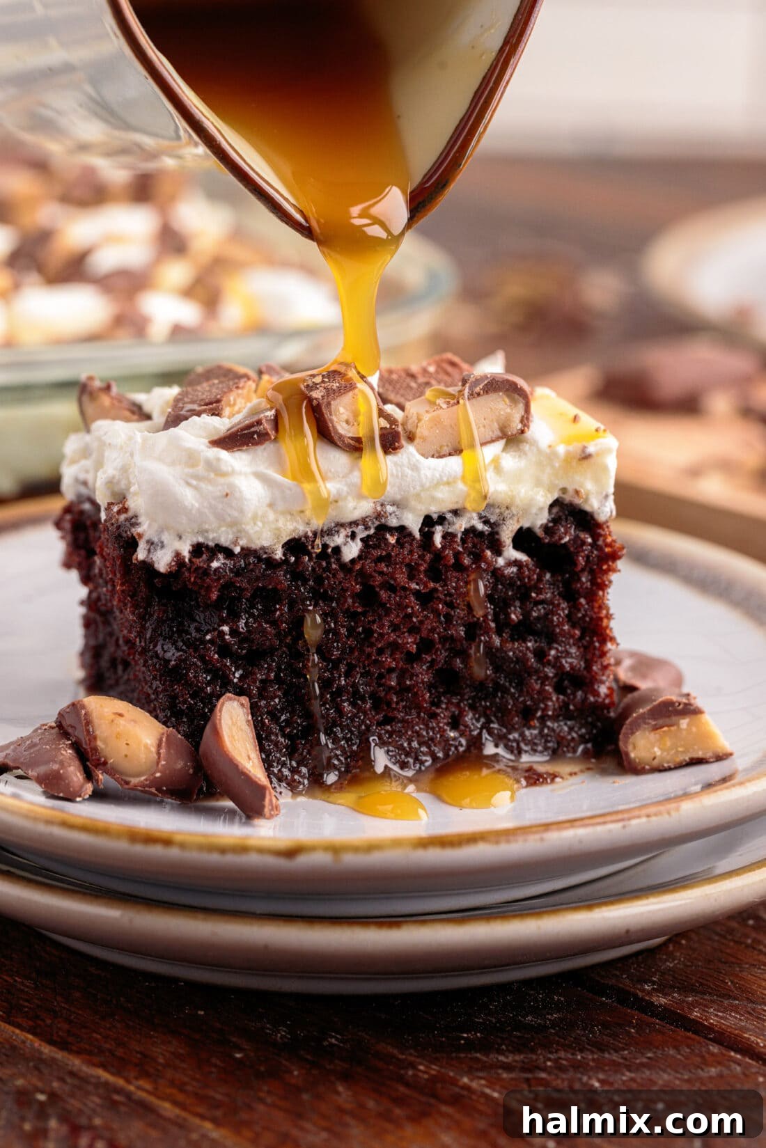A close-up shot of rich caramel being lovingly drizzled over a slice of Better Than Sex Cake, emphasizing its gooey goodness and tempting appeal.