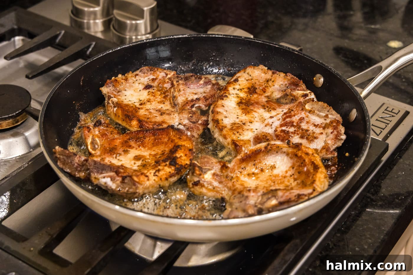 seared pork chops in a skillet