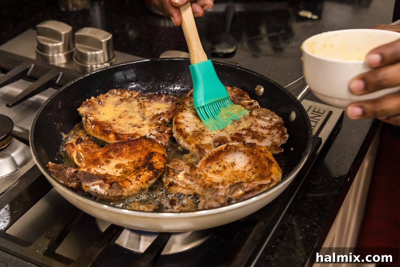 basting garlic butter over pork chops