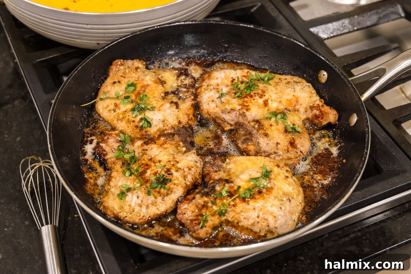 finished garlic butter pork chops in a skillet