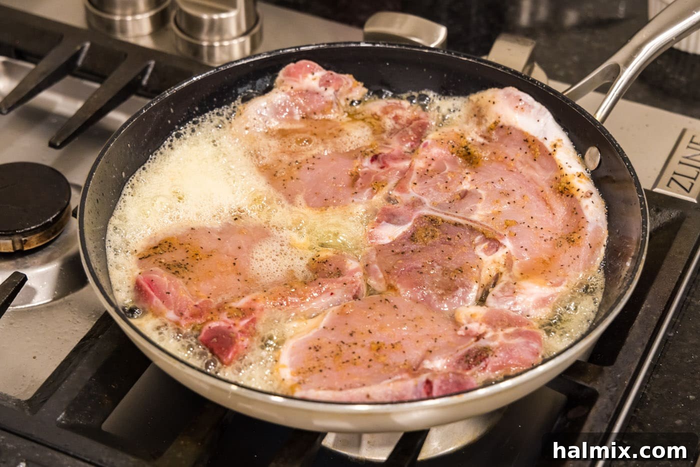 cooking pork chops in a skillet with butter and oil