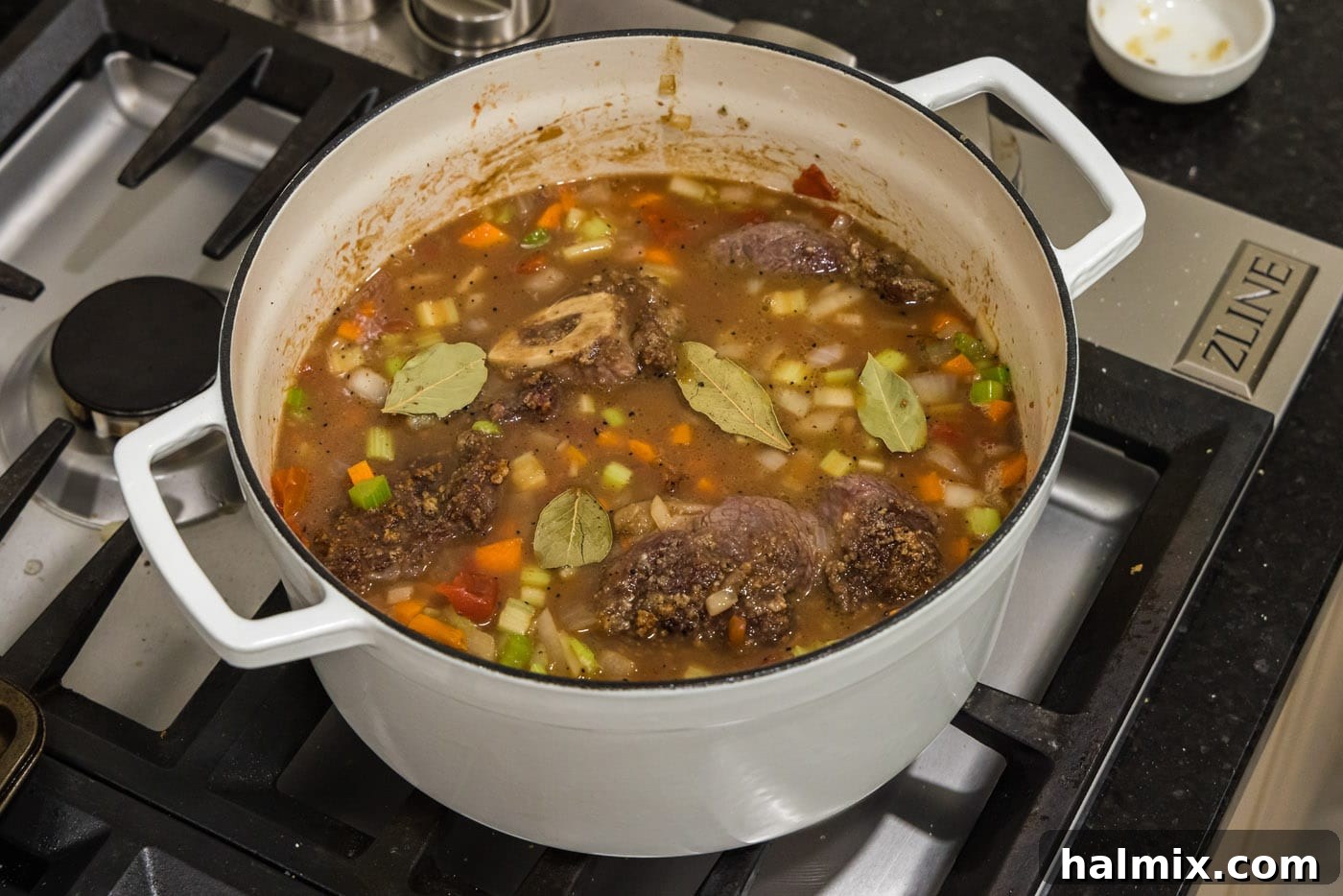 Bay leaves added to braised beef shanks with lid on