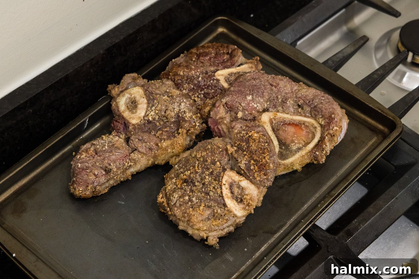 Seared beef shanks resting on a baking pan