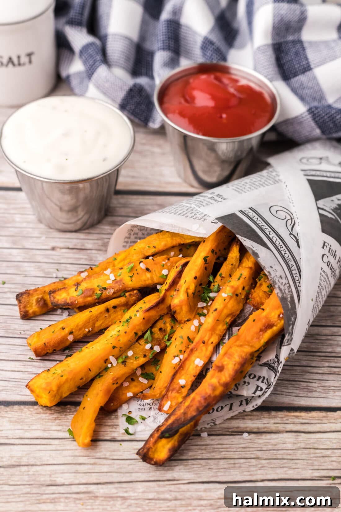 Crispy Air Fryer Sweet Potato Fries wrapped in parchment paper, ready to be served.