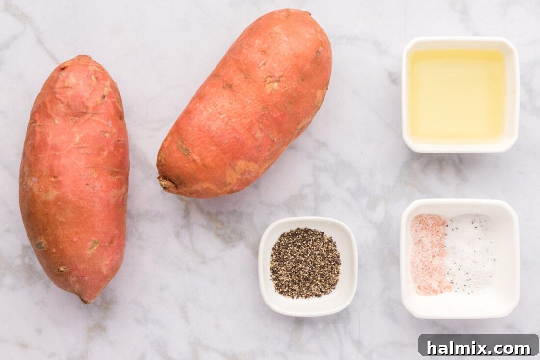 A collection of ingredients laid out on a cutting board, including sweet potatoes, olive oil, salt, and pepper, for Air Fryer Sweet Potato Fries.