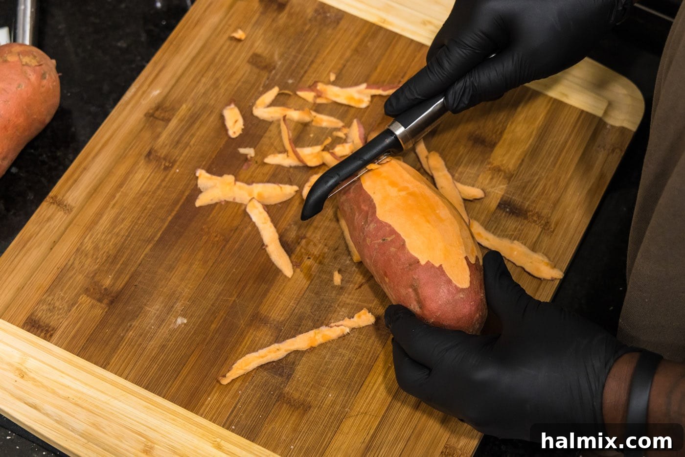 Peeling sweet potatoes, showing the process of removing the skin.