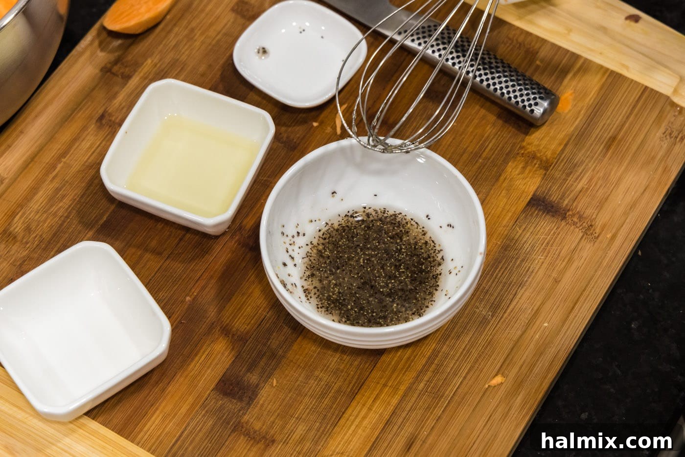 Whisking the oil, salt, and pepper mixture in a small bowl until fully combined.