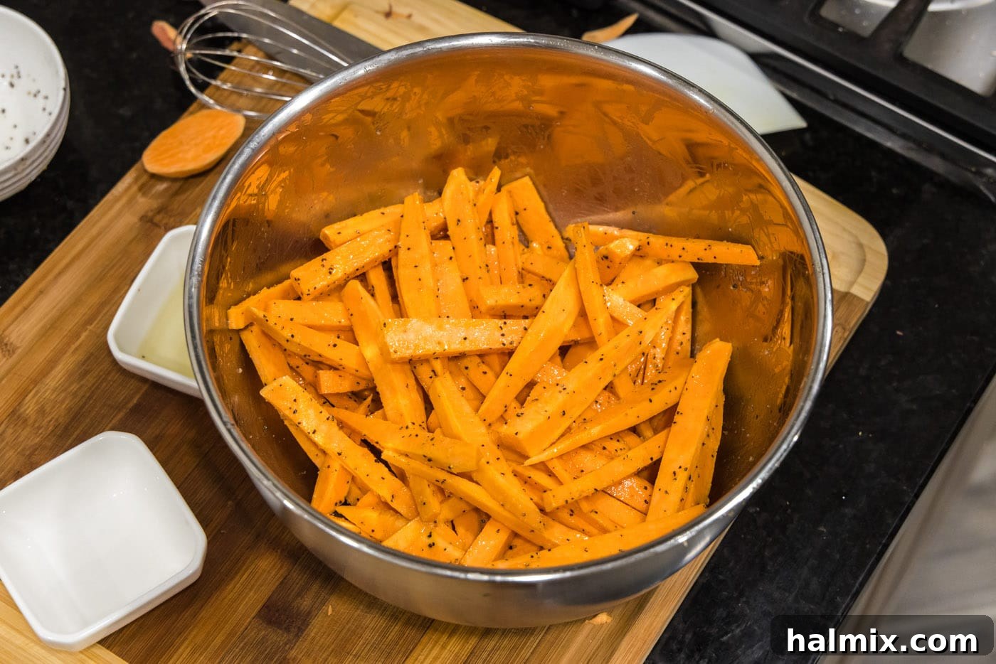 Sweet potato fries tossed evenly in oil and seasonings, ready for the air fryer.