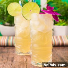 Two Jamaican Mules topped with a lime wheel and a flower, a perfect representation of this tropical cocktail.