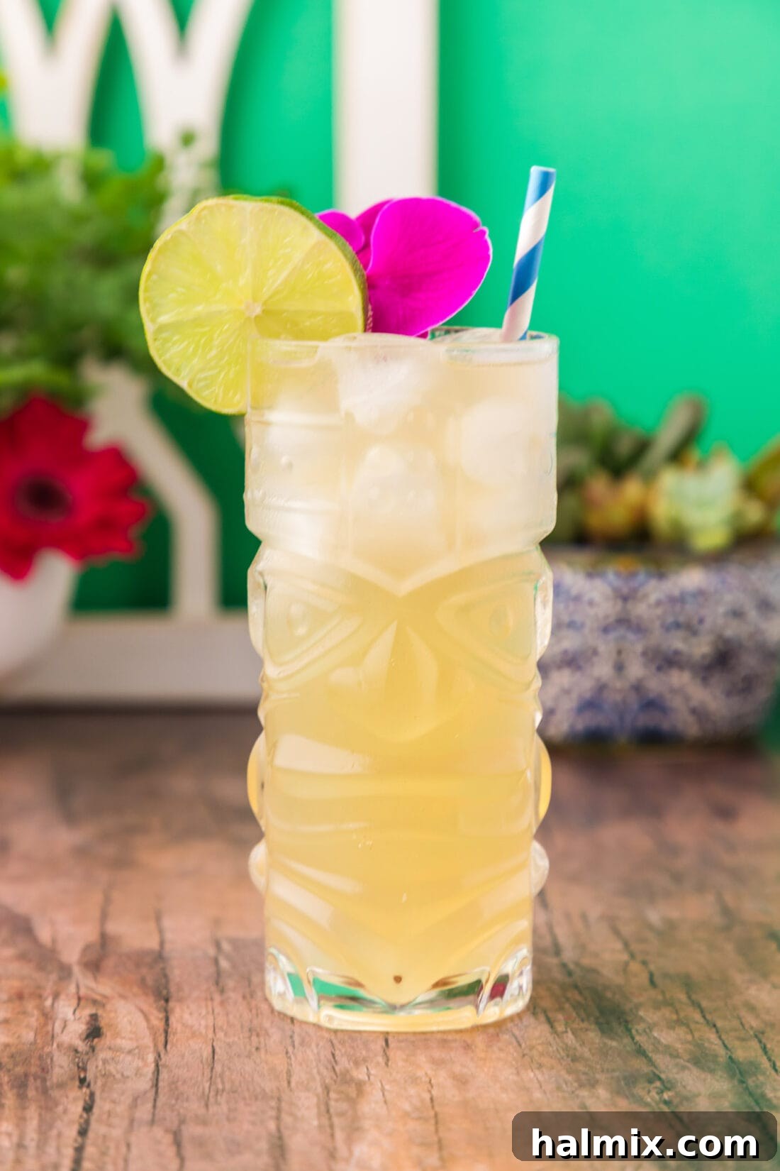 Side photo of a vibrant Jamaican Mule garnished with a lime wheel and an exotic flower, showcasing its tropical appeal.