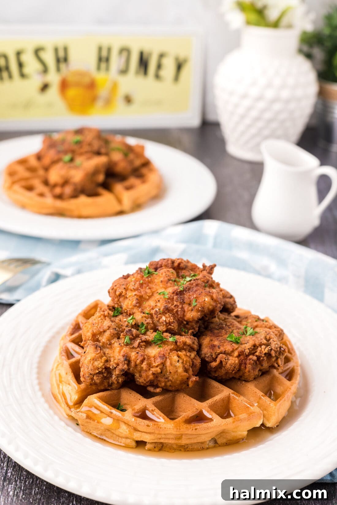 Southern Fried Bliss 2 Two plates of Golden Crispy Chicken and Waffles, ready to be served