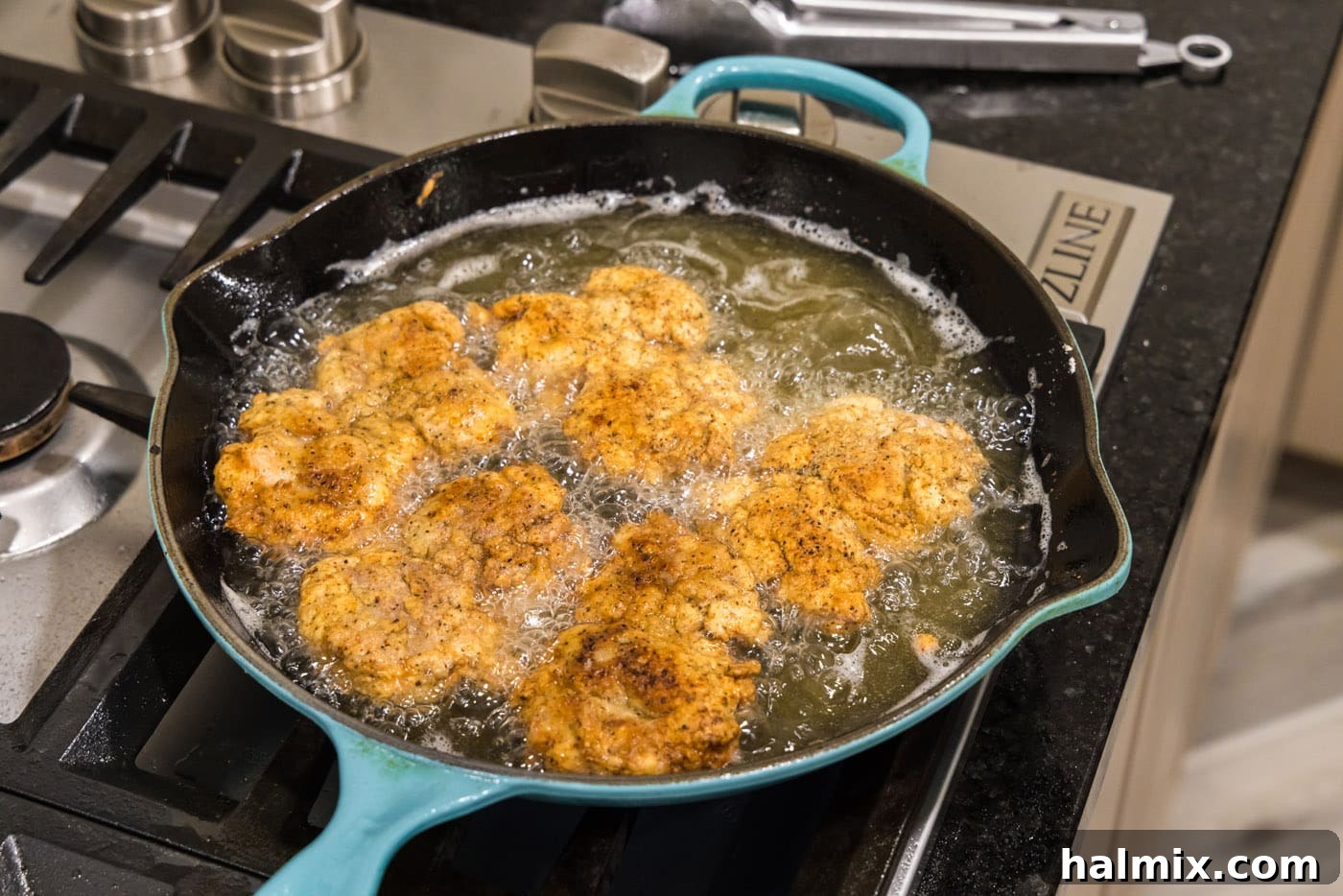 Southern Fried Bliss 15 Multiple fried chicken thighs cooking in a skillet, almost ready