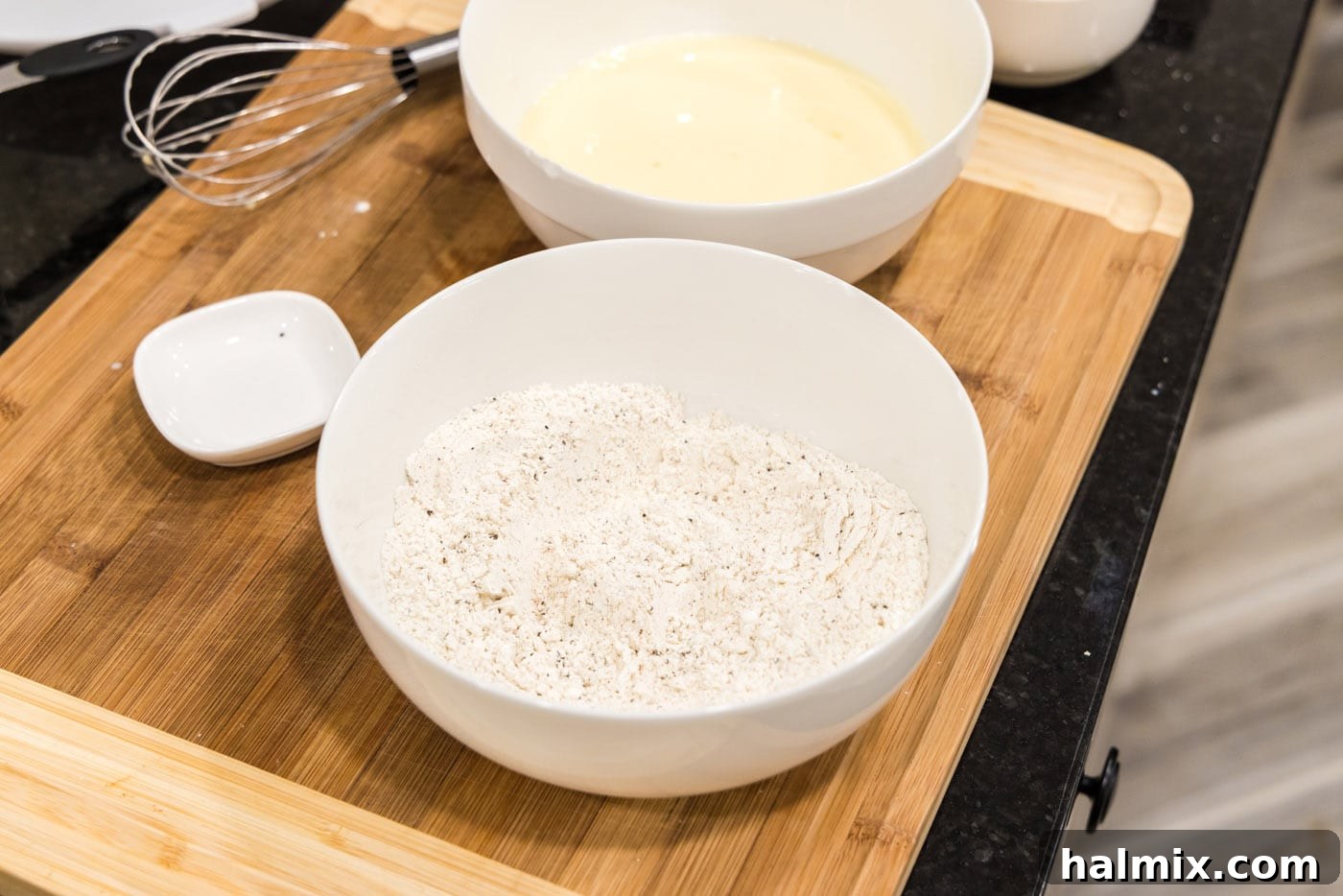 Southern Fried Bliss 7 A bowl containing a dry mix of flour, cornstarch, Slap Ya Mama seasoning, garlic salt, and black pepper