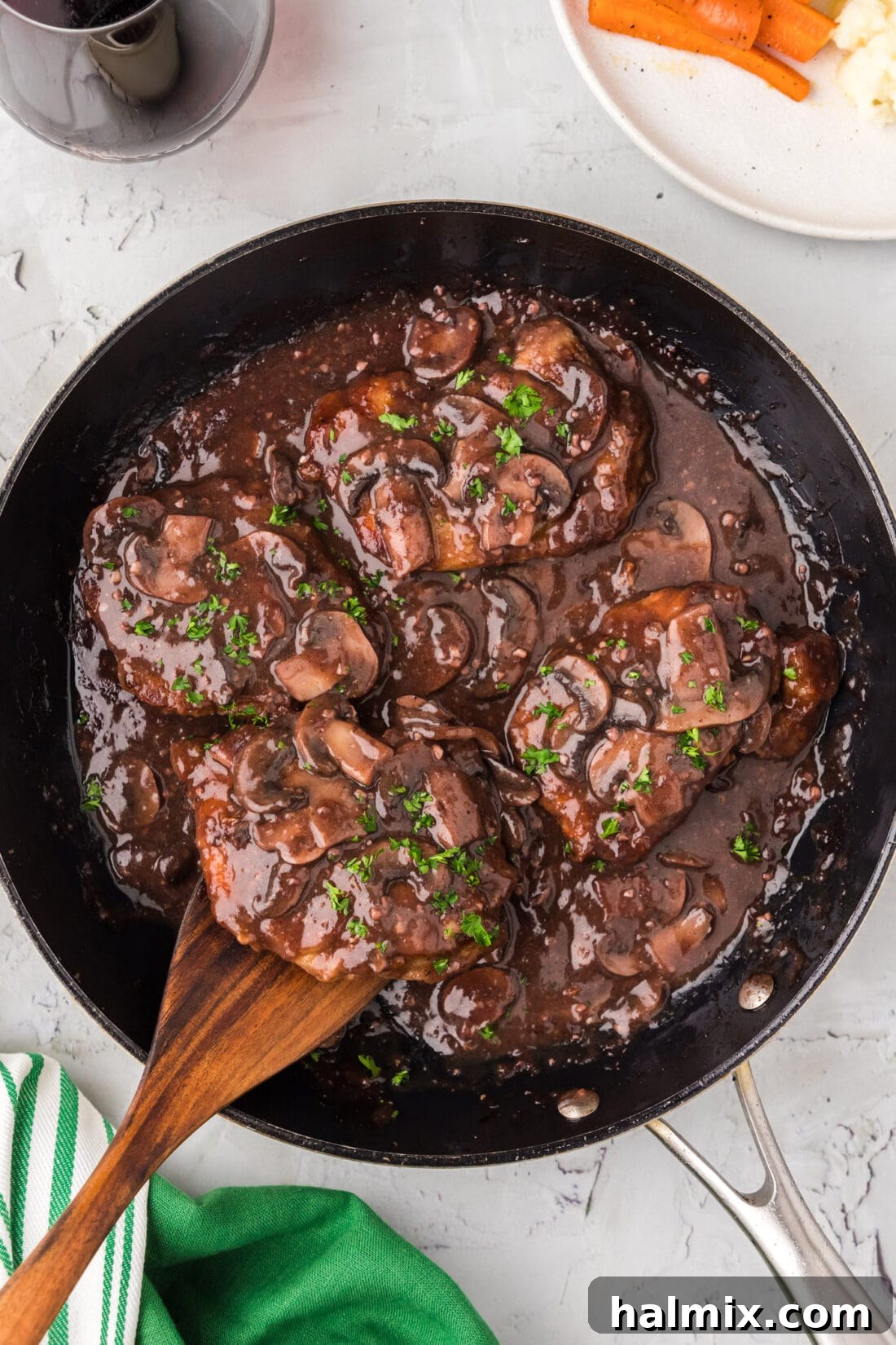 Marsala Veal: Italian Elegance 2 Golden-brown veal Marsala cooking in a skillet with earthy mushrooms, ready to be served