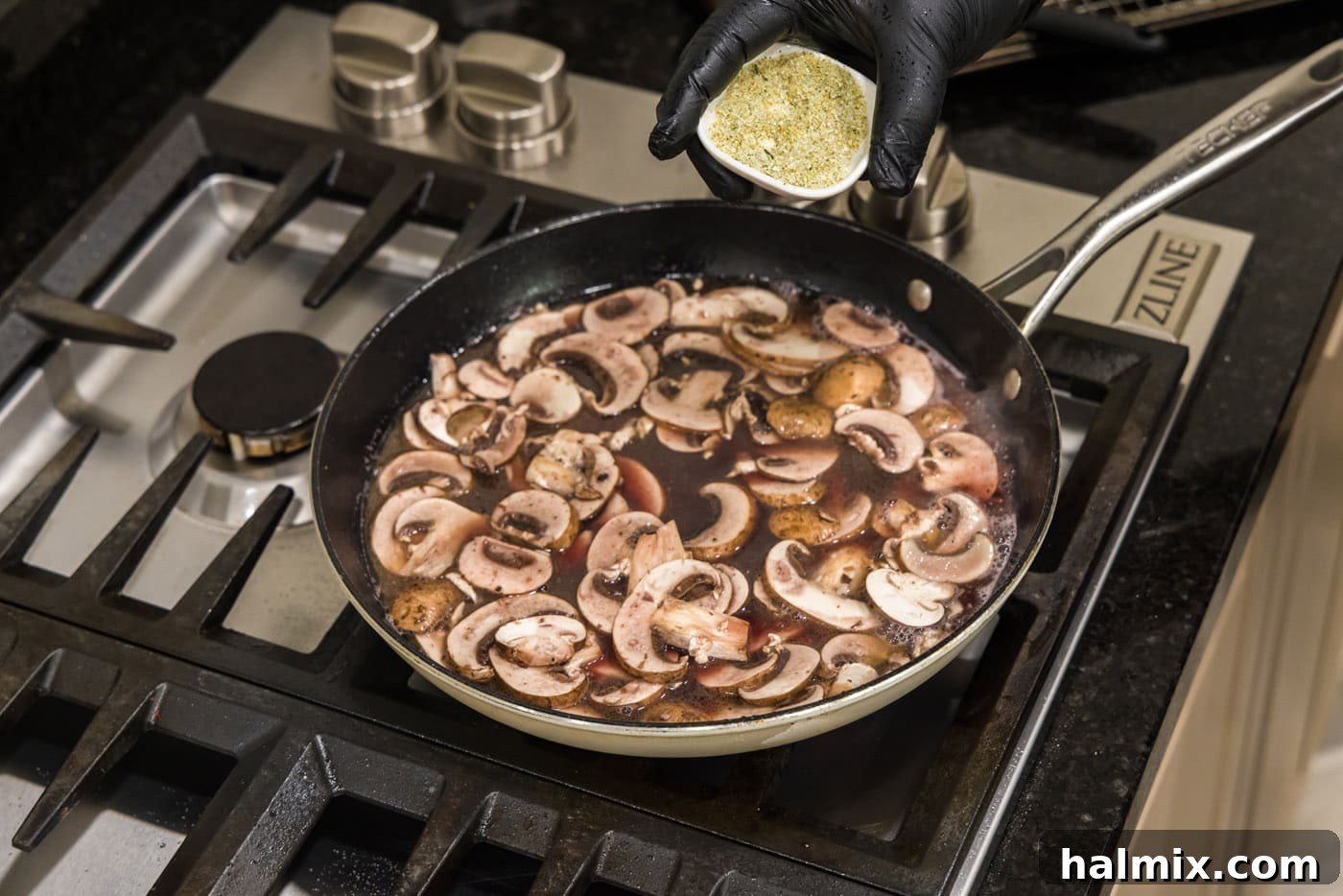 Marsala Veal: Italian Elegance 11 Sliced mushrooms simmering in a rich Marsala wine and chicken stock sauce in a skillet