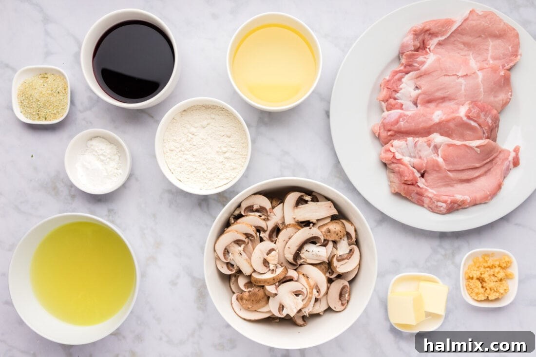 Marsala Veal: Italian Elegance 4 Fresh ingredients laid out for preparing Veal Marsala, including veal, mushrooms, wine, and herbs