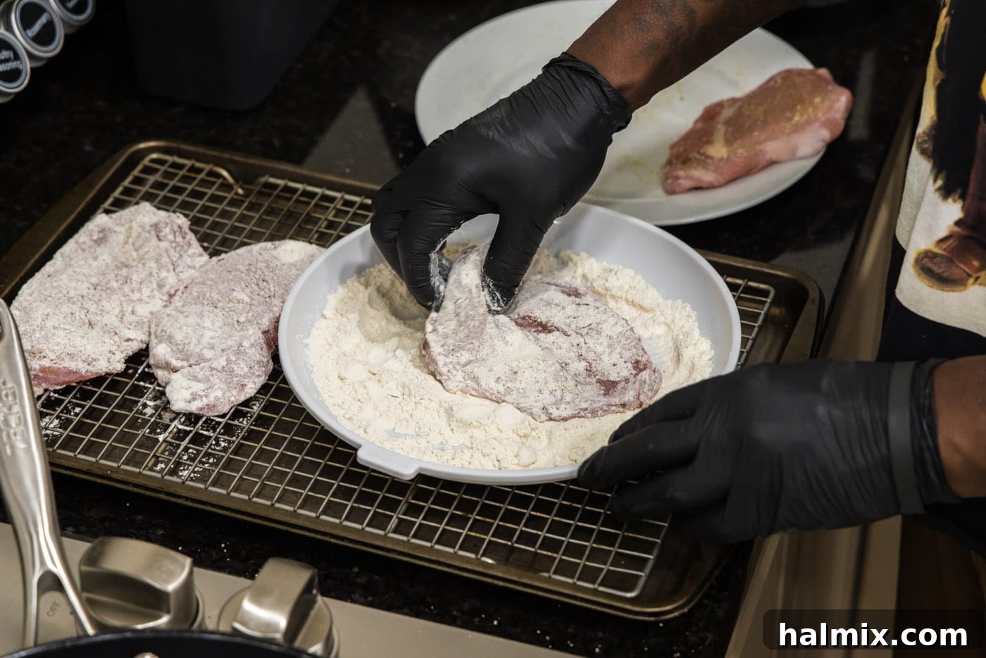 Marsala Veal: Italian Elegance 6 Close-up view of a veal cutlet being dredged in flour on a plate, ensuring full coverage