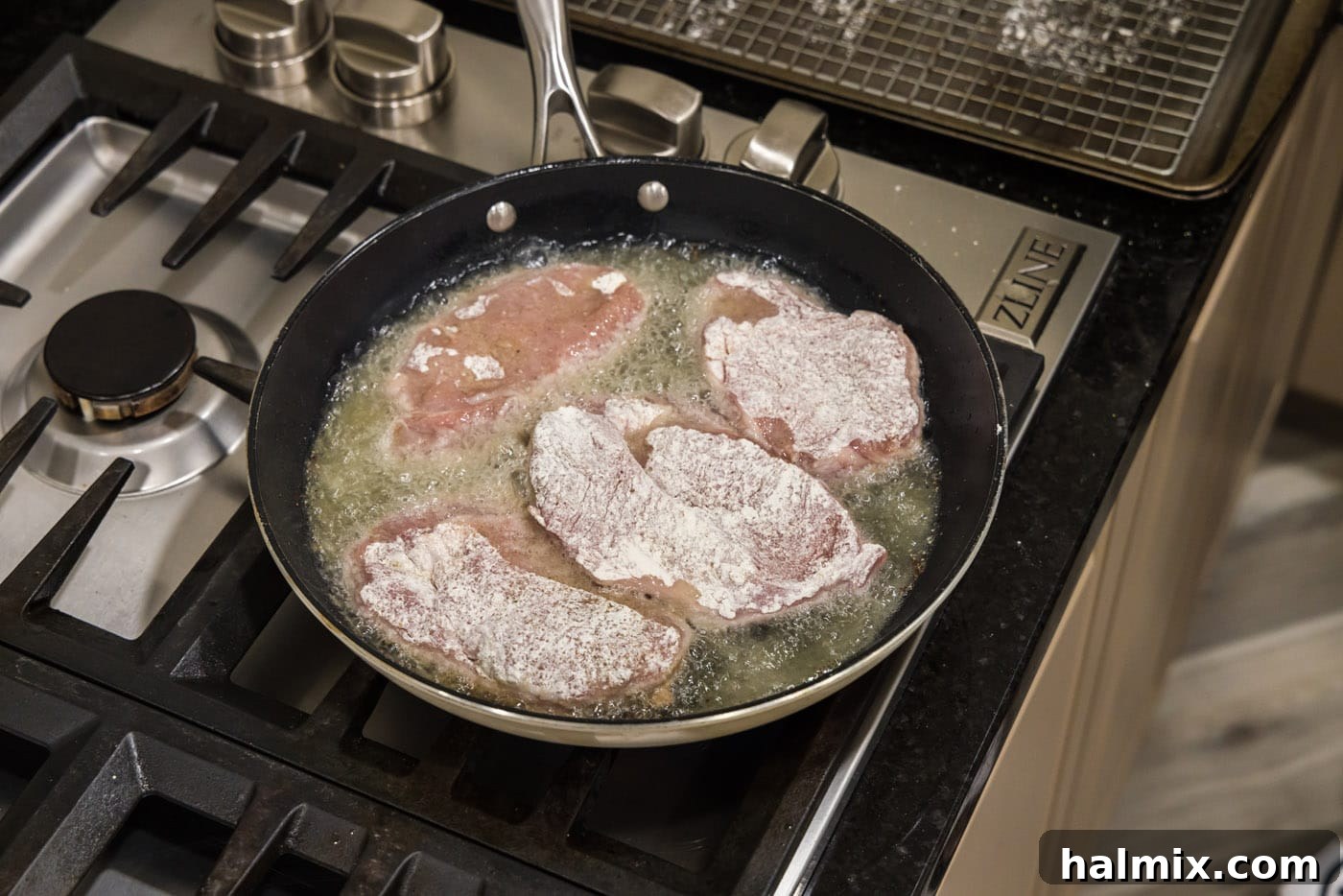Marsala Veal: Italian Elegance 7 Flour-coated veal cutlets sizzling and turning golden brown in a skillet of hot oil