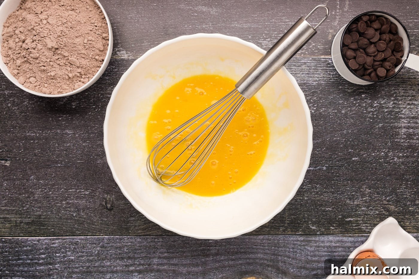 eggs, oil, and vanilla whisked in a bowl