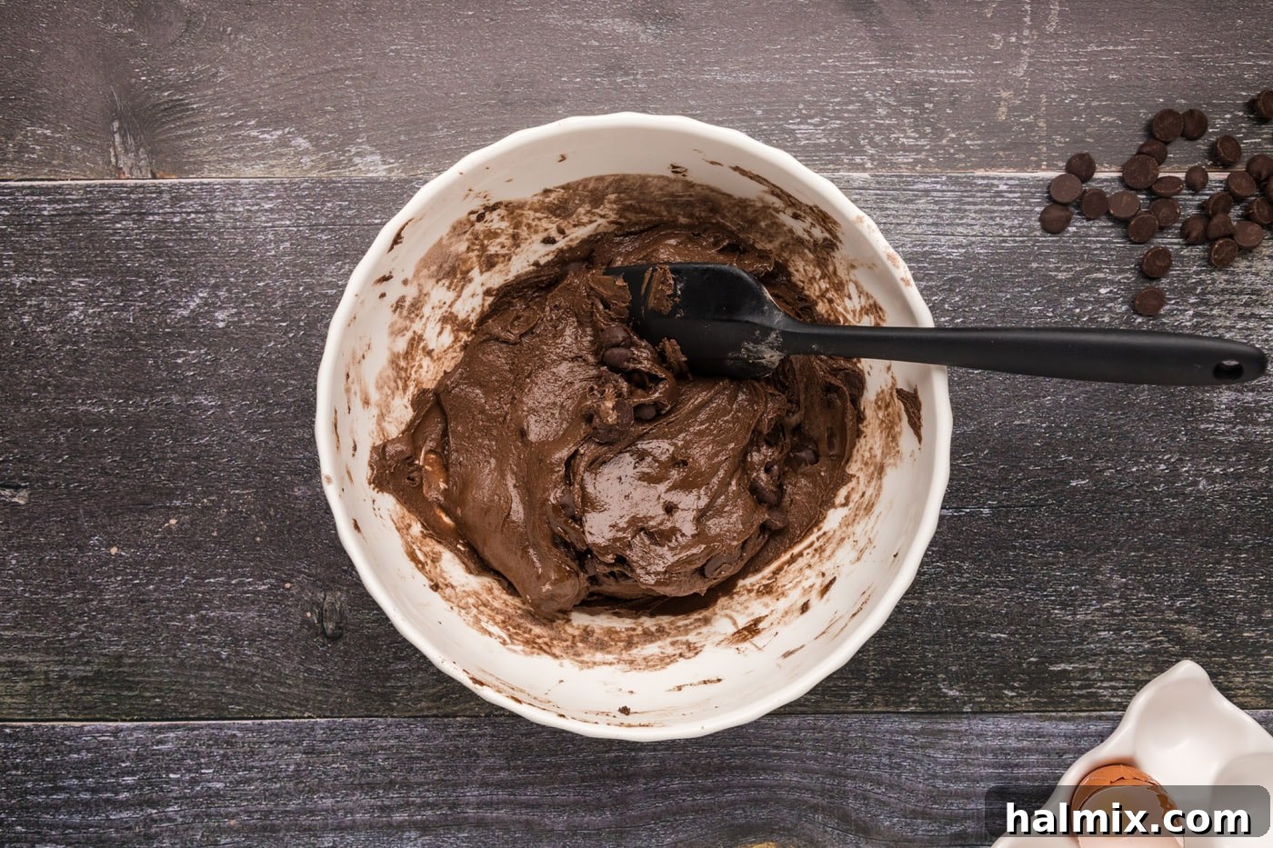brownie batter in a bowl with dark chocolate chips