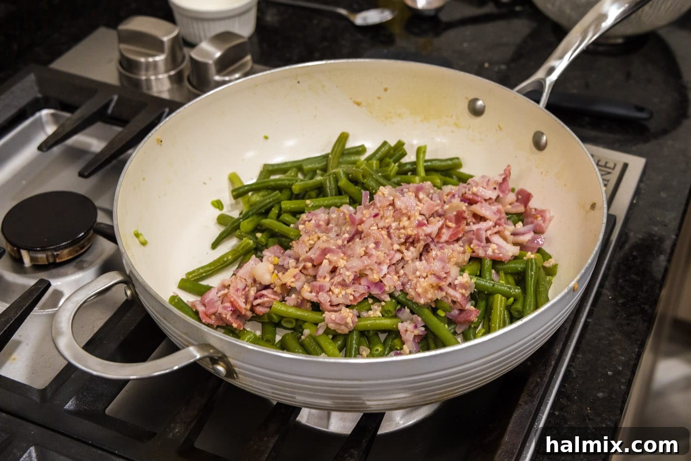 Old Fashioned Southern Green Beans 11 Adding the reserved shallots, bacon, and garlic back into the cooked green beans