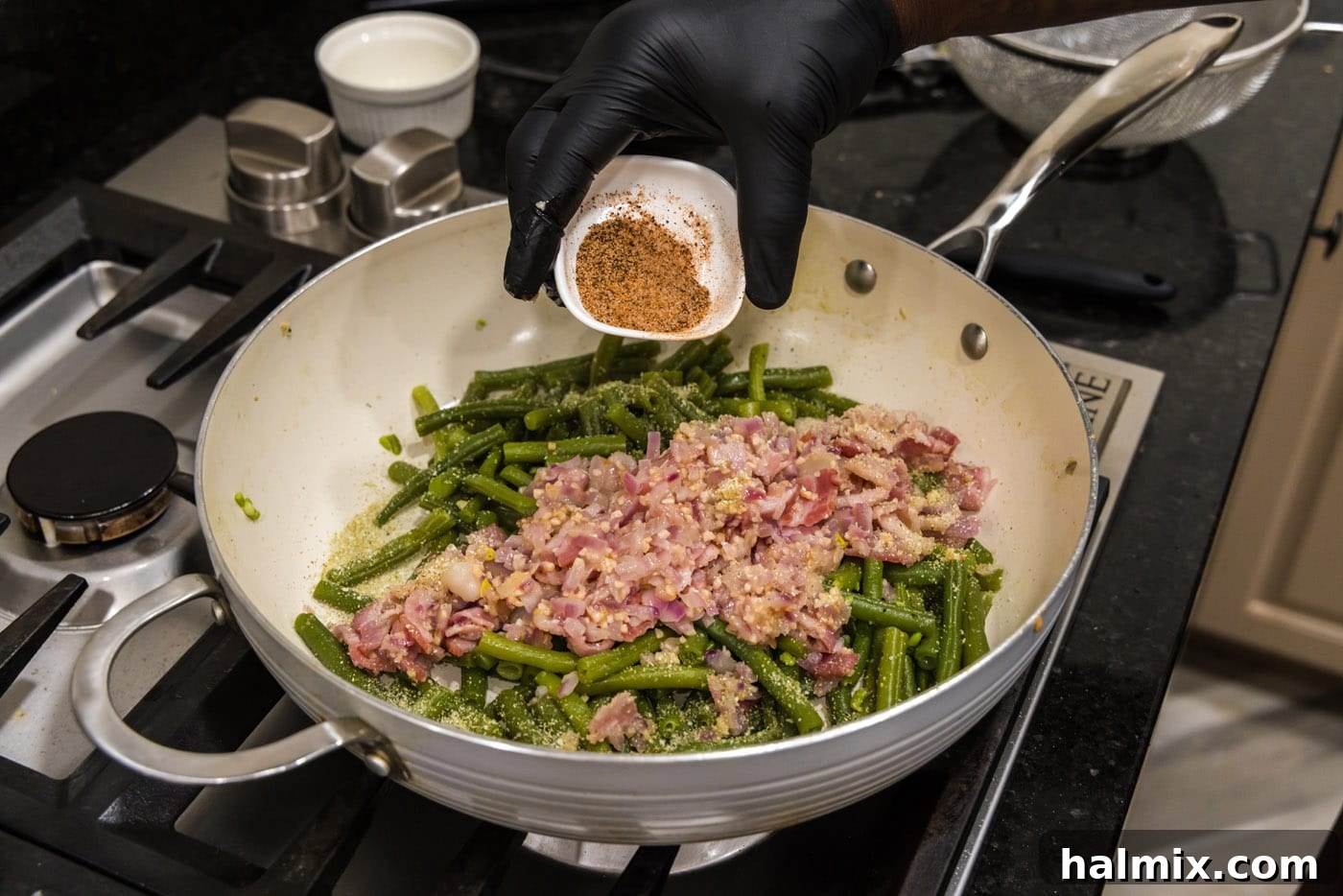 Old Fashioned Southern Green Beans 12 Adding the final touch of Cajun seasoning to the southern green beans