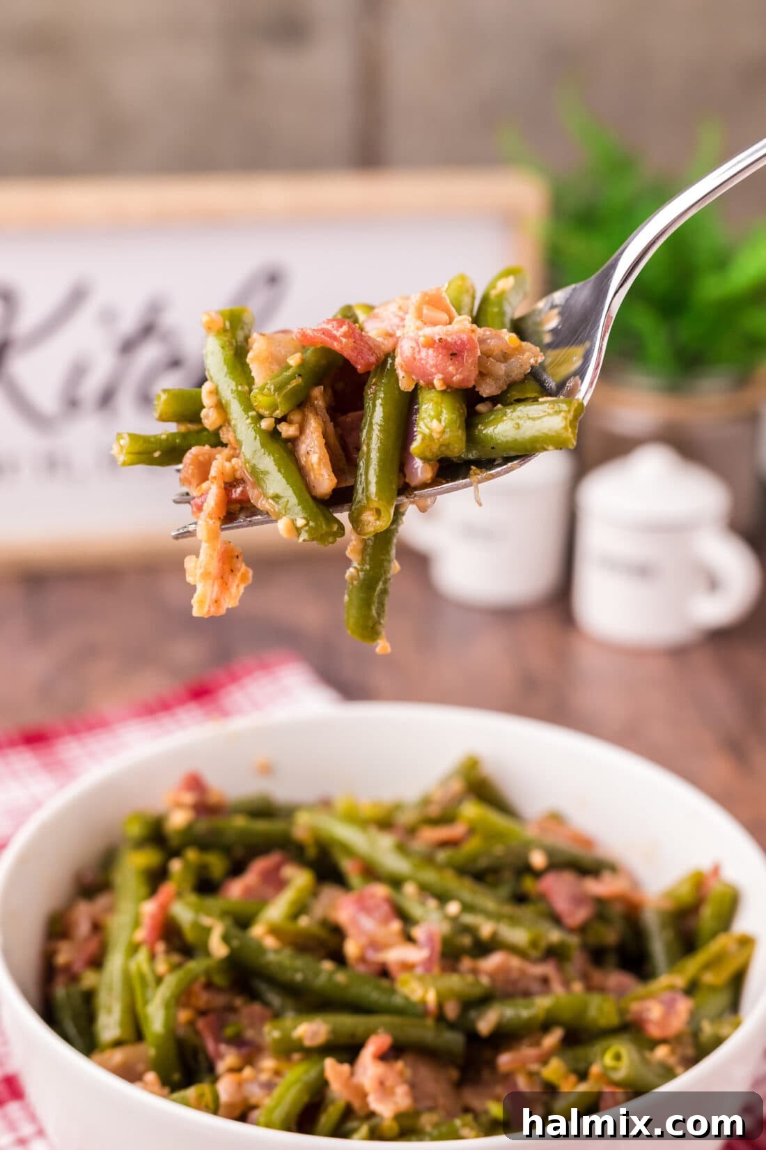 Old Fashioned Southern Green Beans 3 Fork lifting a portion of tender Southern Green Beans from a bowl