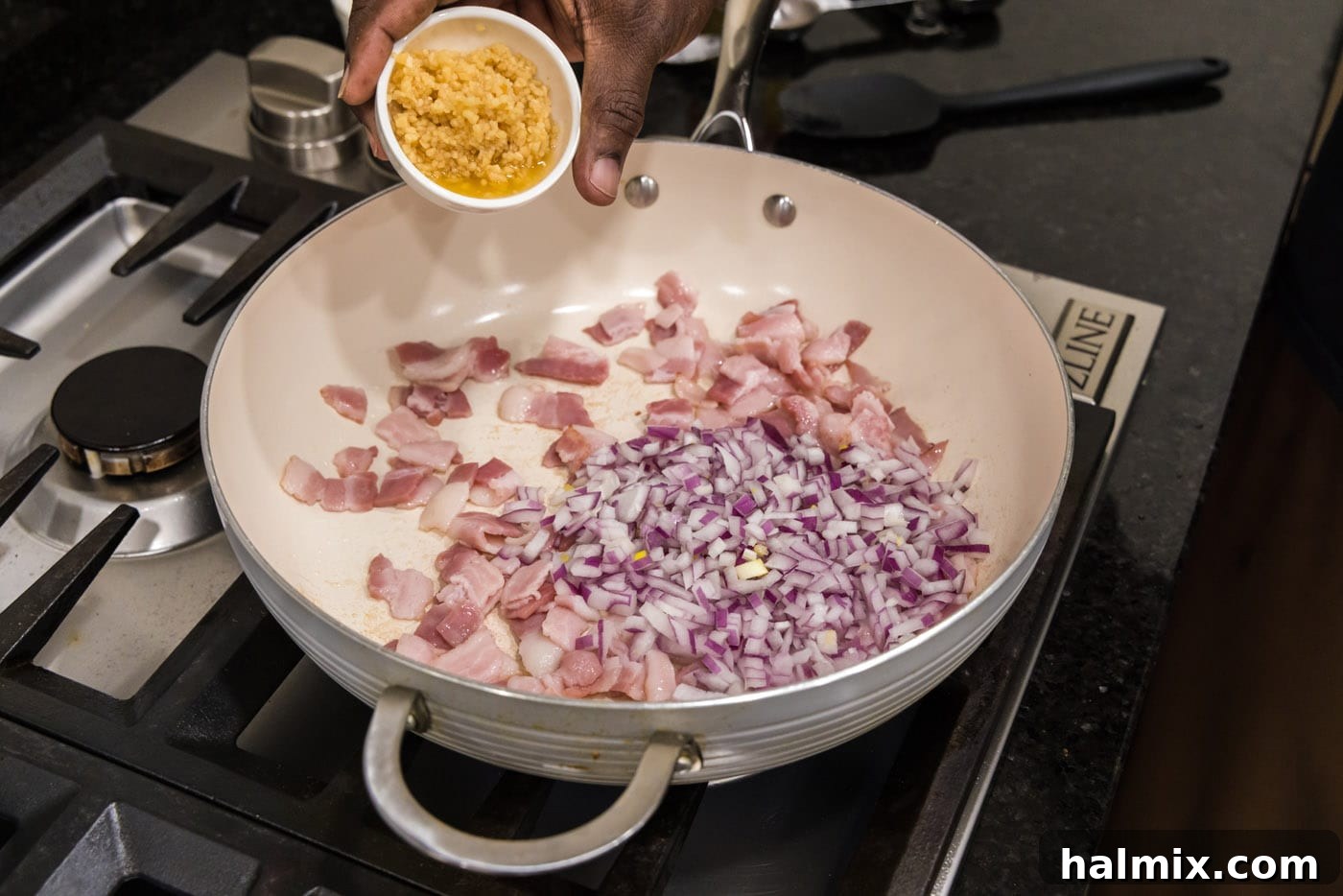 Old Fashioned Southern Green Beans 5 Adding minced garlic to a skillet with cooking shallots and bacon