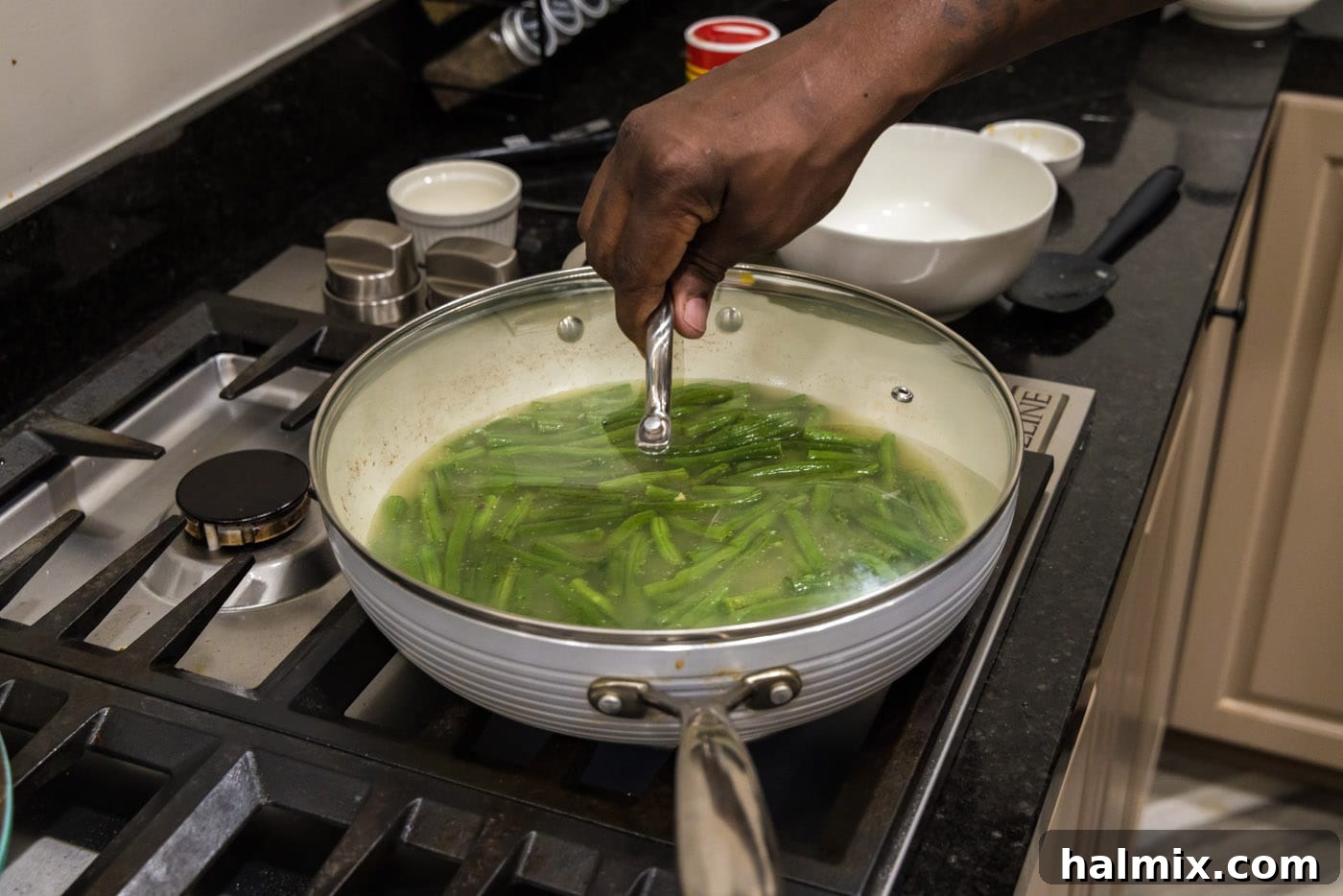 Old Fashioned Southern Green Beans 10 Placing the lid on the skillet to cook the green beans