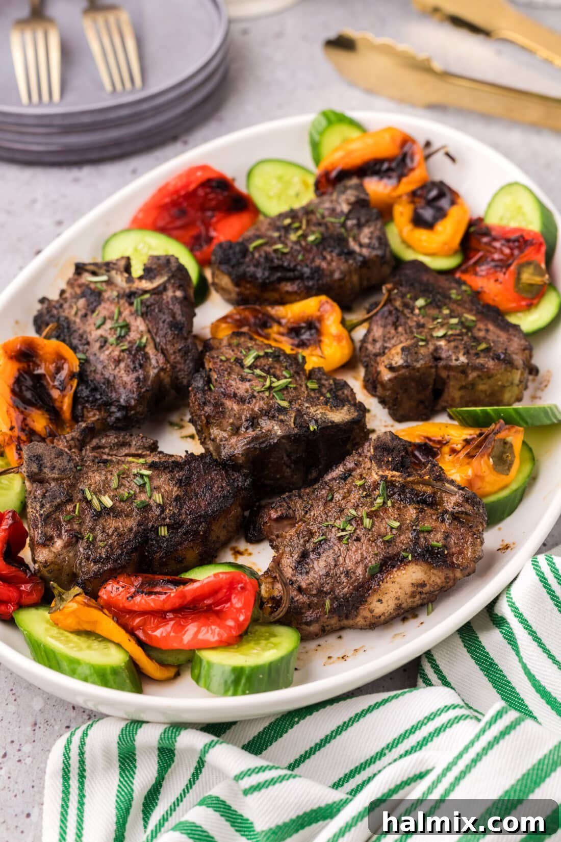 Chargrilled Lamb Loins 2 Grilled Lamb Loin Chops on a platter with vegetables