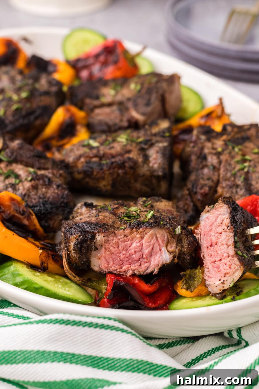 Chargrilled Lamb Loins 13 Piece of Grilled Lamb Loin Chop on a fork