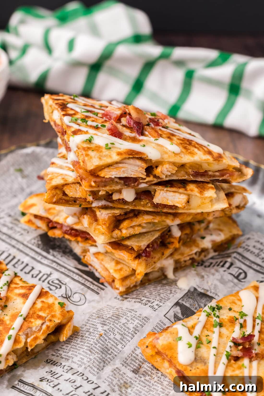 Crispy Ranch Chicken Bacon Quesadillas 2 Stack of Golden Brown Chicken Bacon Ranch Quesadillas topped with a drizzle of ranch dressing, ready to be served.