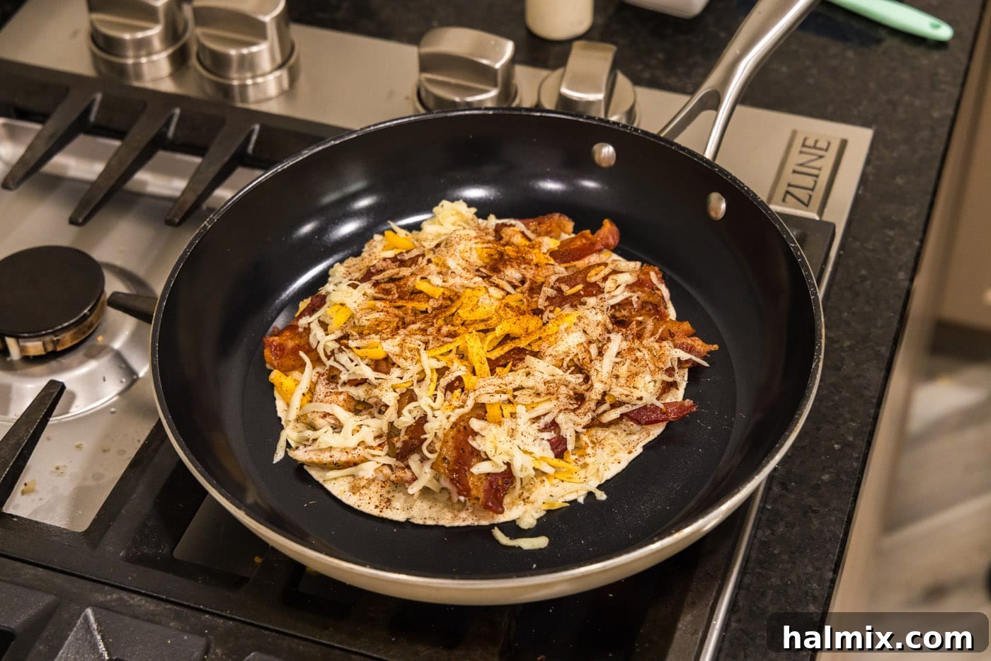 Crispy Ranch Chicken Bacon Quesadillas 14 A chicken bacon ranch quesadilla base being carefully placed into a hot skillet.