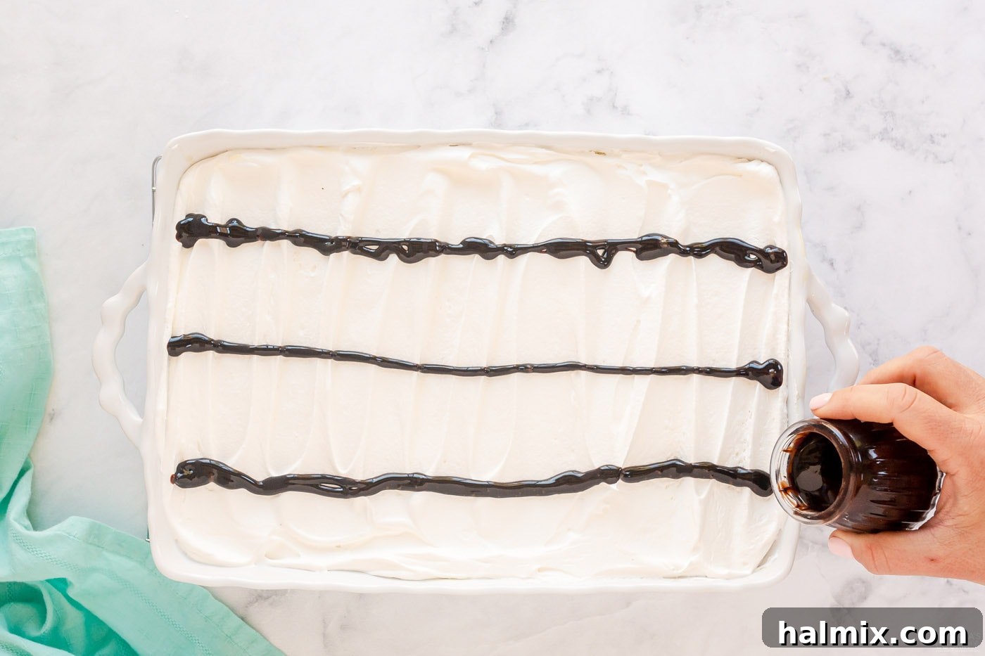 Chocolate Eclair Cloud Cake 13 pouring lines of chocolate on top of cake