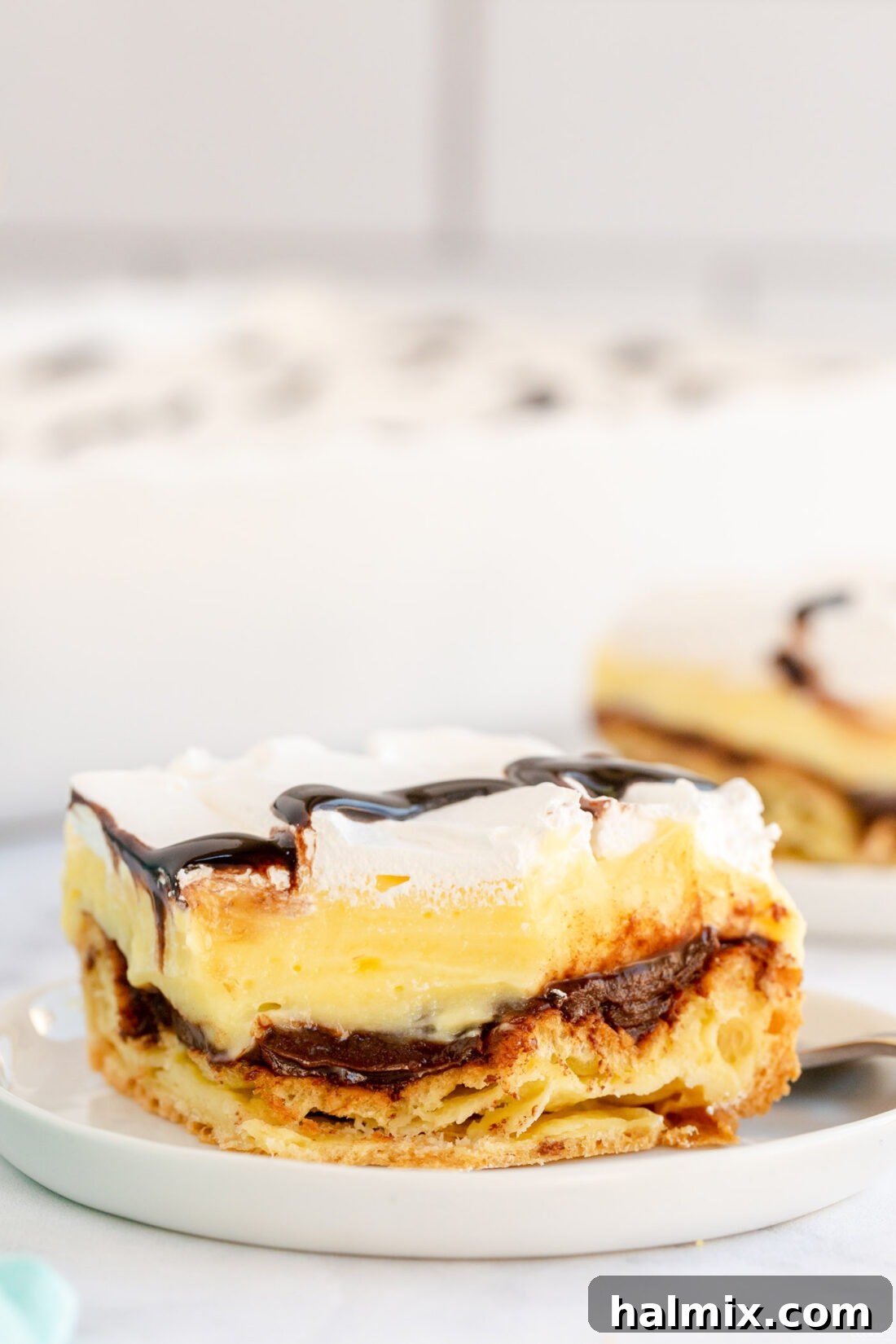 Chocolate Eclair Cloud Cake 3 slice of Cream Puff Chocolate Eclair Cake on plate