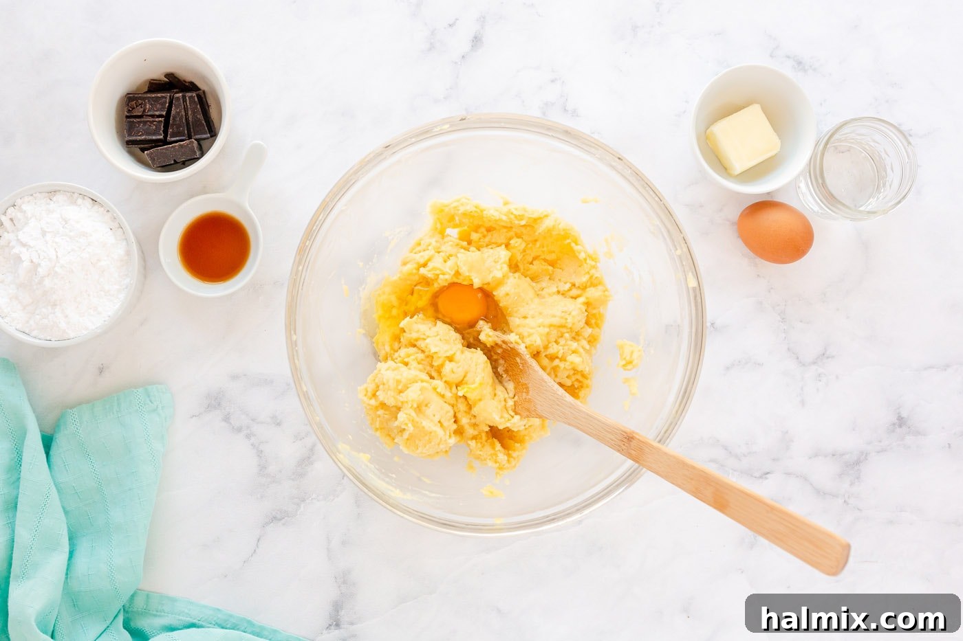 Chocolate Eclair Cloud Cake 6 mixing dough with wooden spoon in a bowl