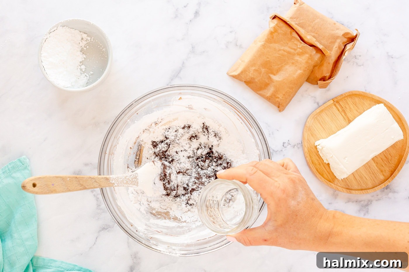 Chocolate Eclair Cloud Cake 9 mixing chocolate filling in bowl while pouring in water