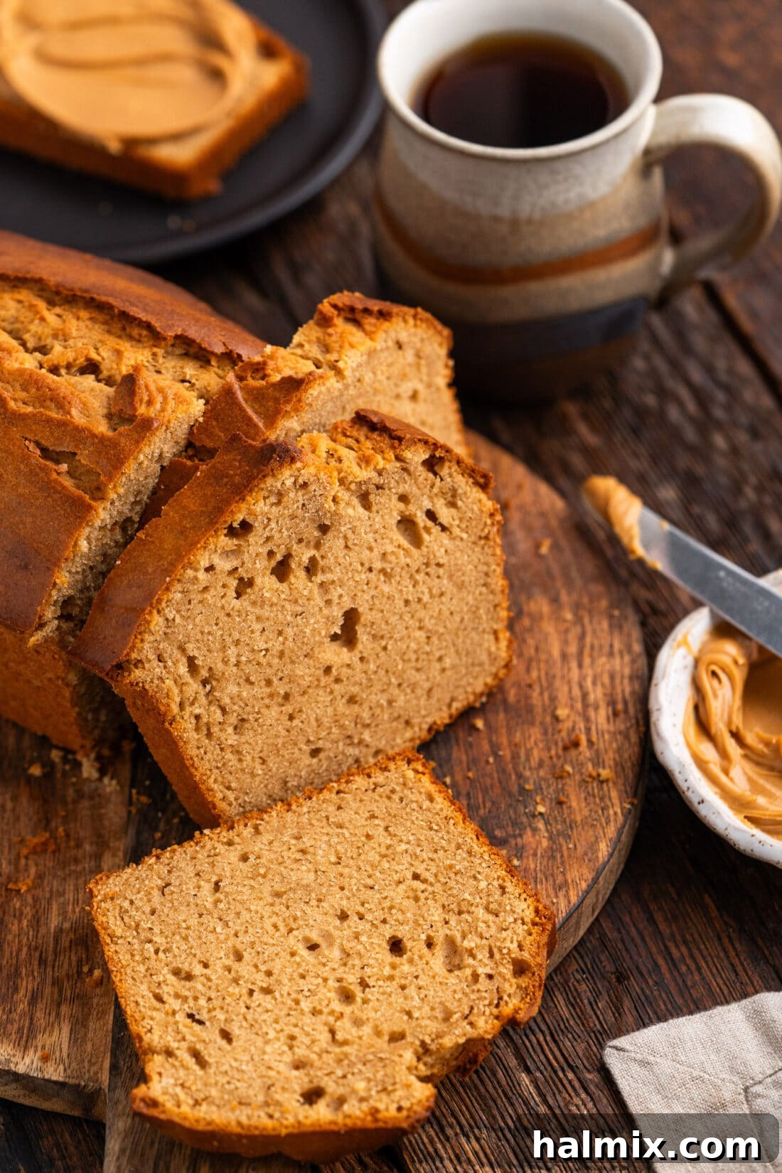 Loaf of Peanut Butter Bread cut into slices, showcasing its tender crumb and golden crust.