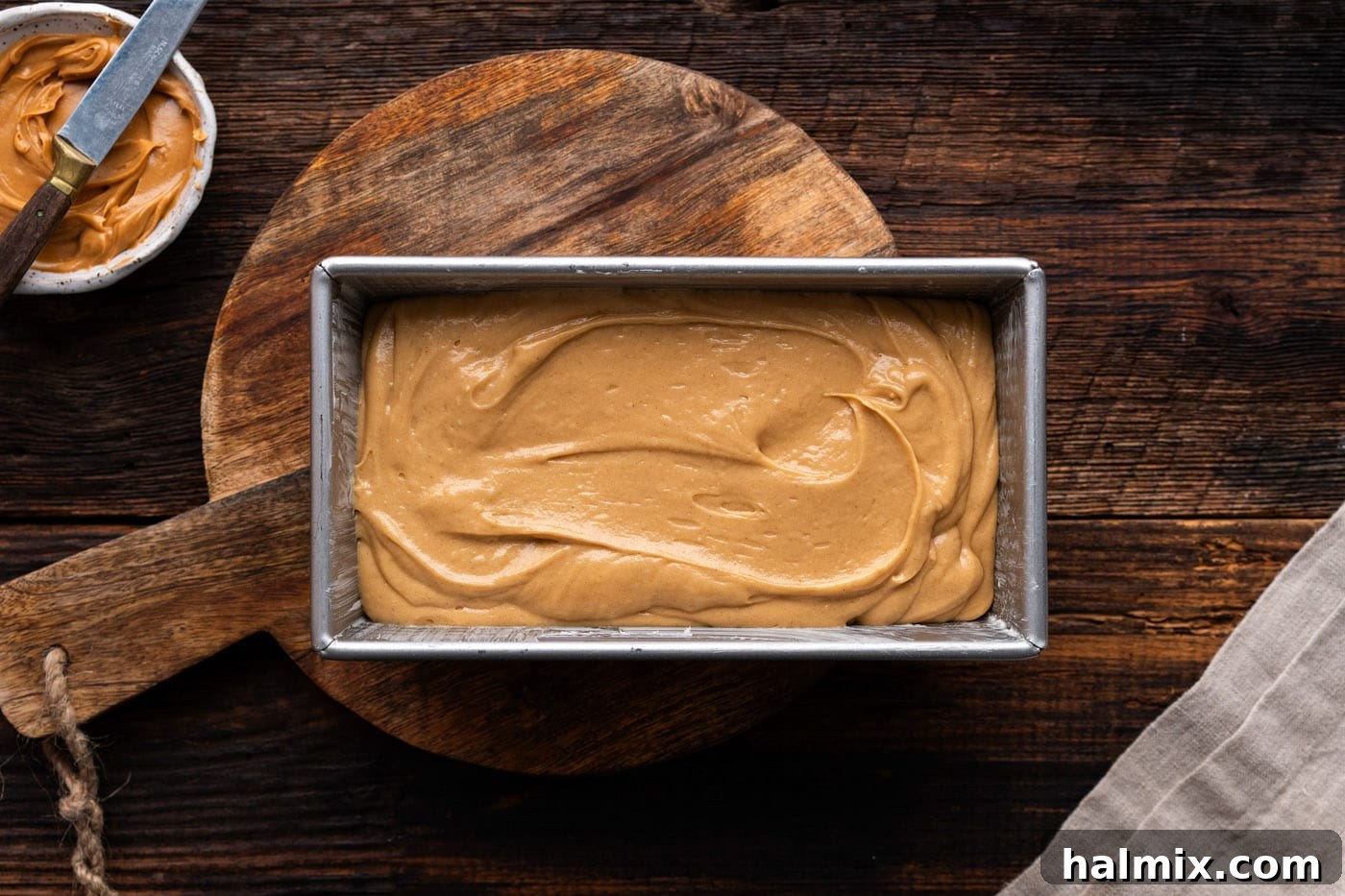 Peanut butter bread batter poured into a loaf pan, ready for baking.