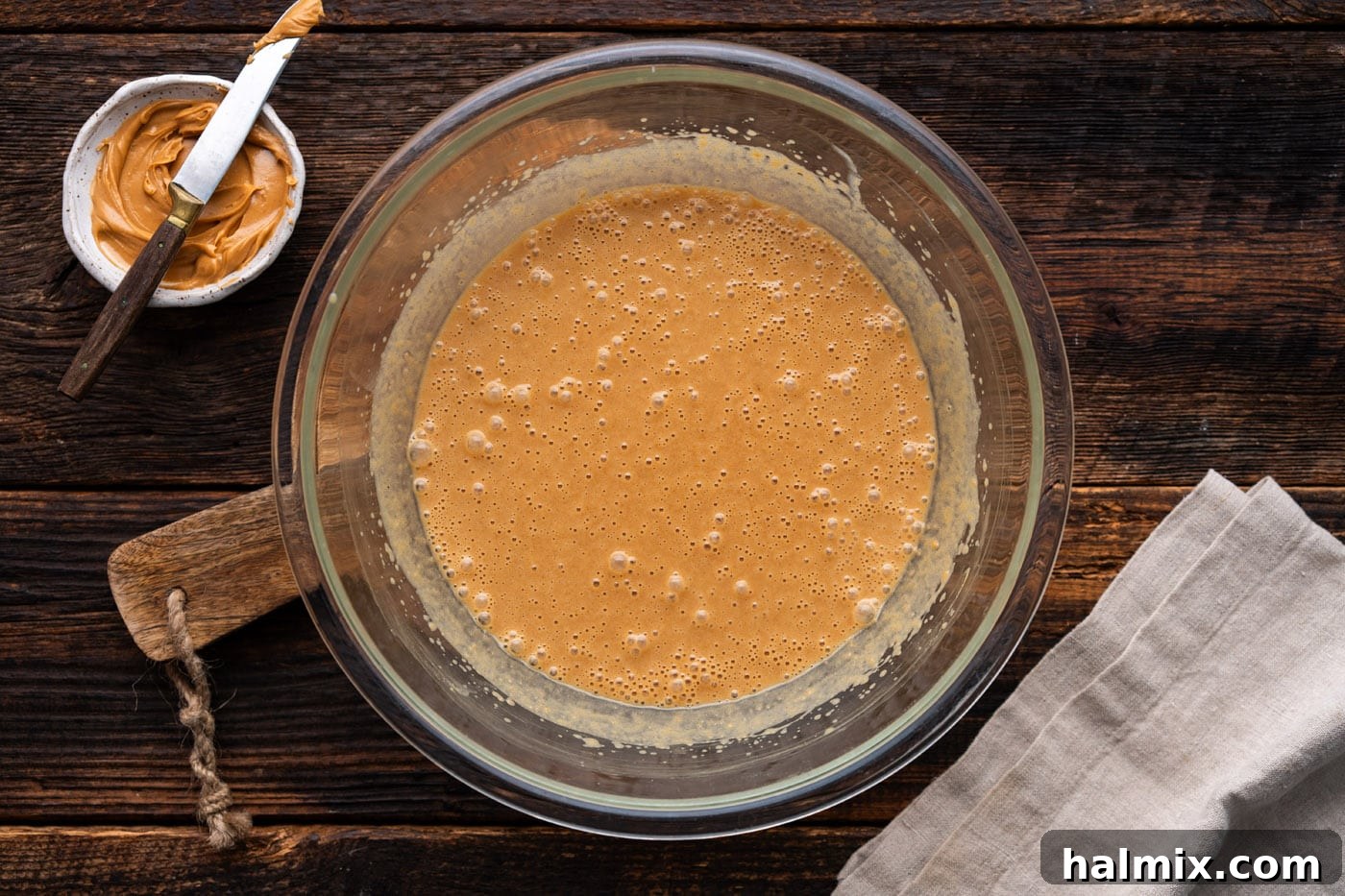 The fully combined wet batter for peanut butter bread, smooth and ready for dry ingredients.