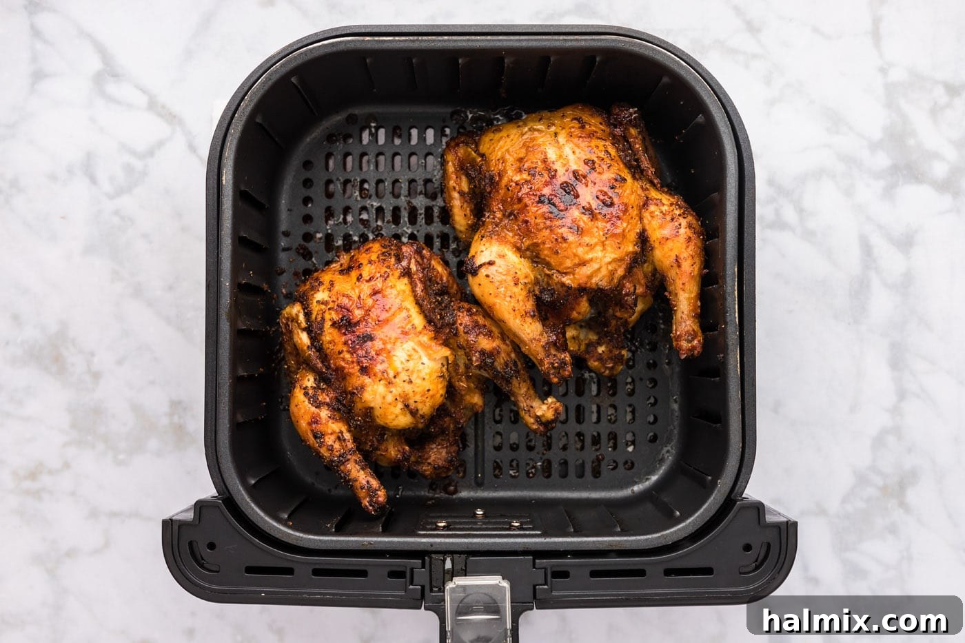 Perfectly crispy, golden brown air fryer Cornish hens after completion of the cooking process.