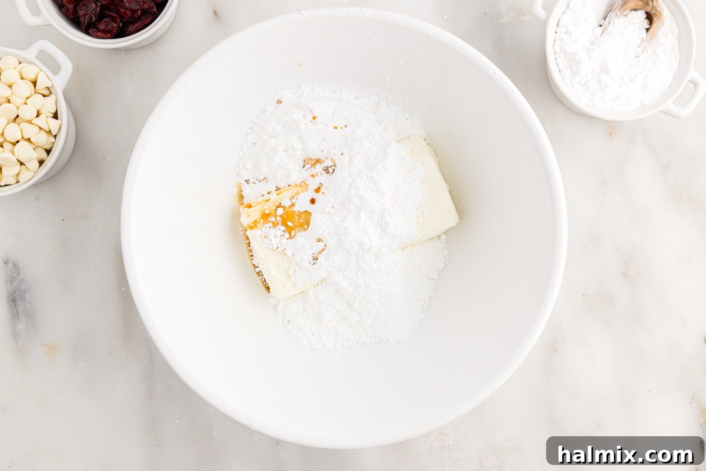 Tangy Cranberry Dream Bars 11 powdered sugar, cream cheese, and orange oil in a mixing bowl